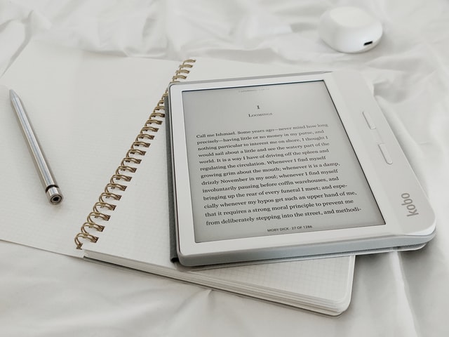 Ebook on top of a notebook